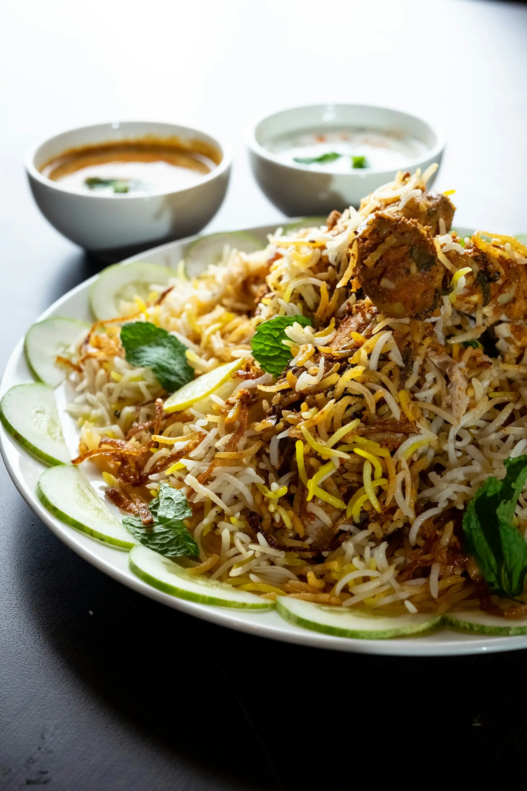 A plate of biryani, garnished and ready to serve
